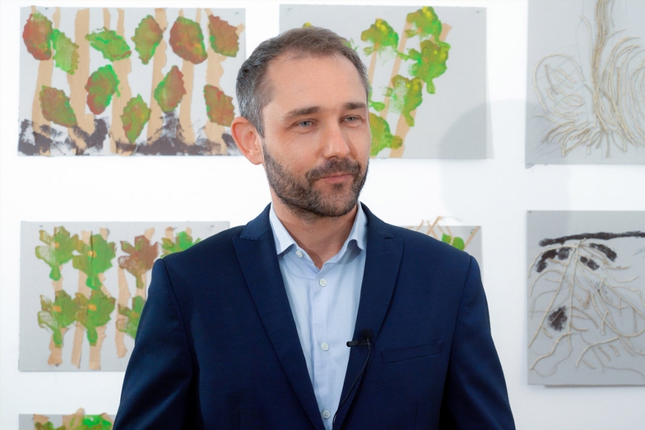 A person standing in front of a wall.