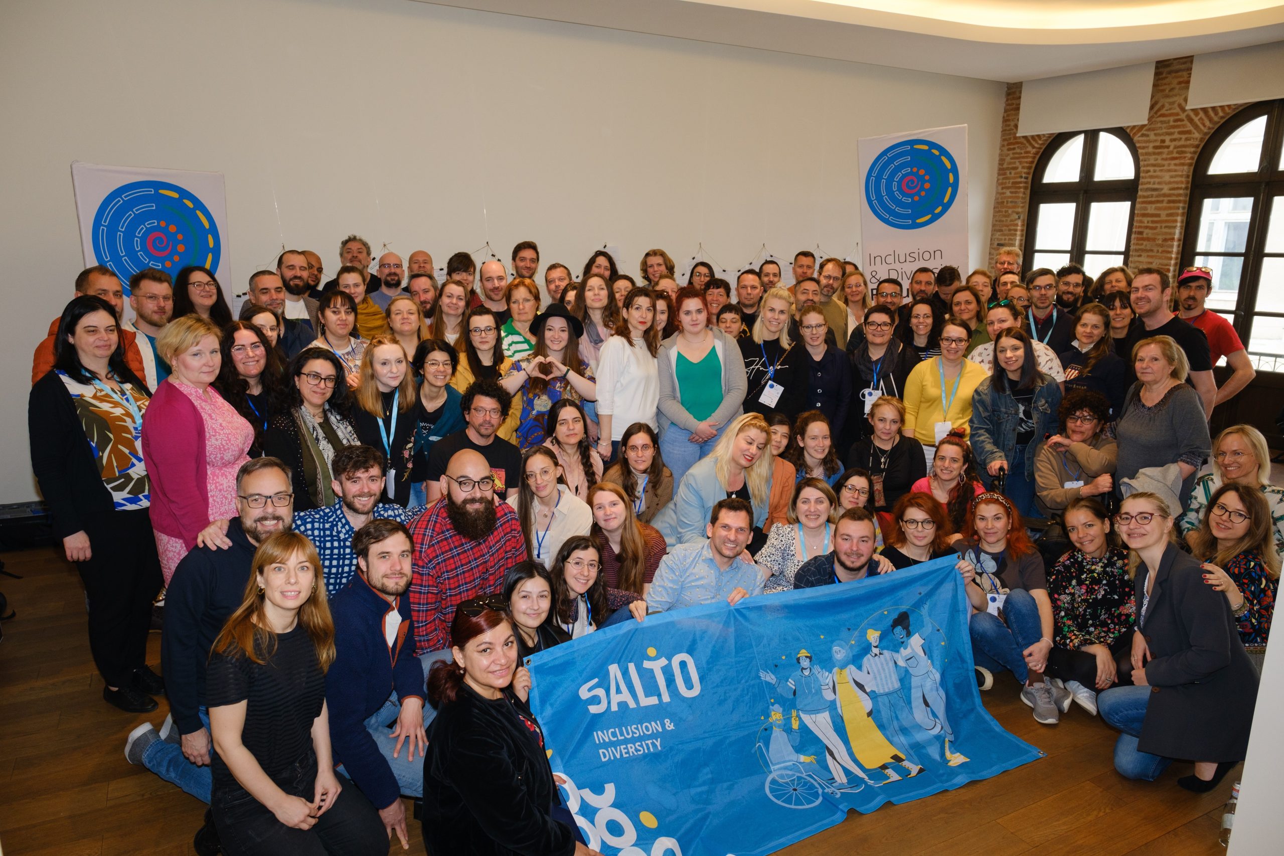 A group photo of participants in a conference room.