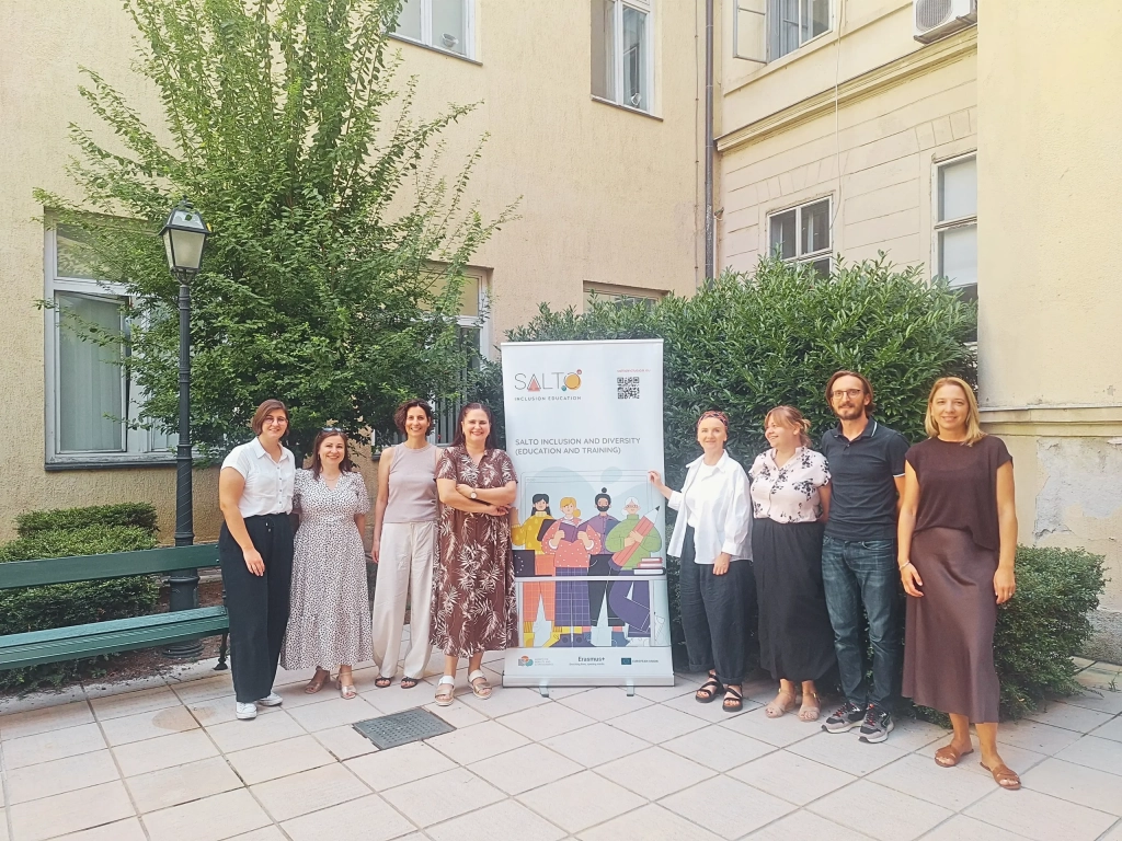 Staff from SALTO ID ET, the Croatian Agency for Mobility and EU Programmes, and the Czech National Agency for International Education and Research pose together outdoors beside a SALTO Inclusion and Diversity banner during a job shadowing visit.