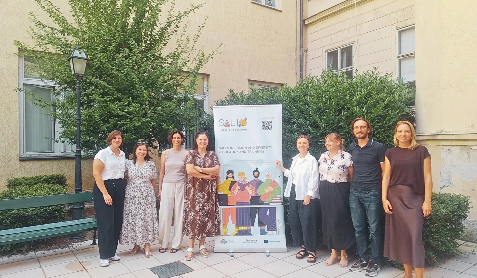 Staff from SALTO ID ET, the Croatian Agency for Mobility and EU Programmes, and the Czech National Agency for International Education and Research pose together outdoors beside a SALTO Inclusion and Diversity banner during a job shadowing visit.